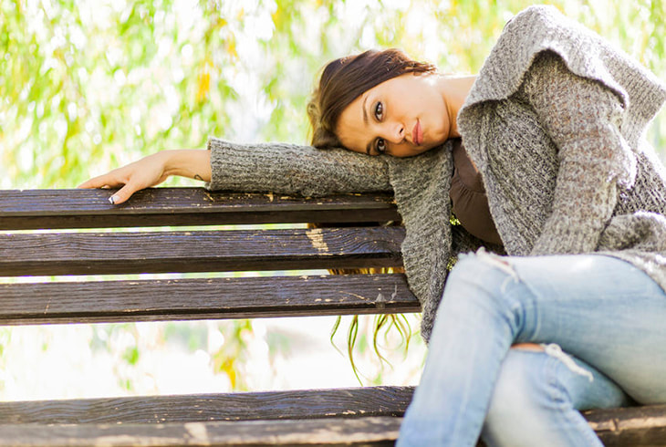 Depressed woman sitting on a bench