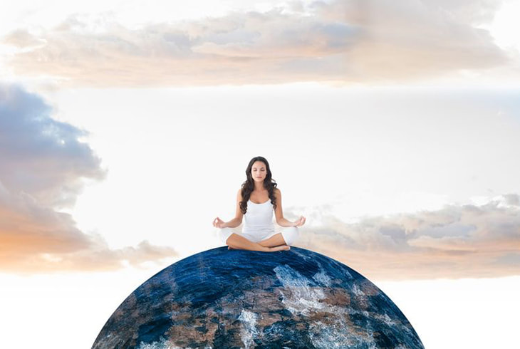image: woman meditating on top of the world