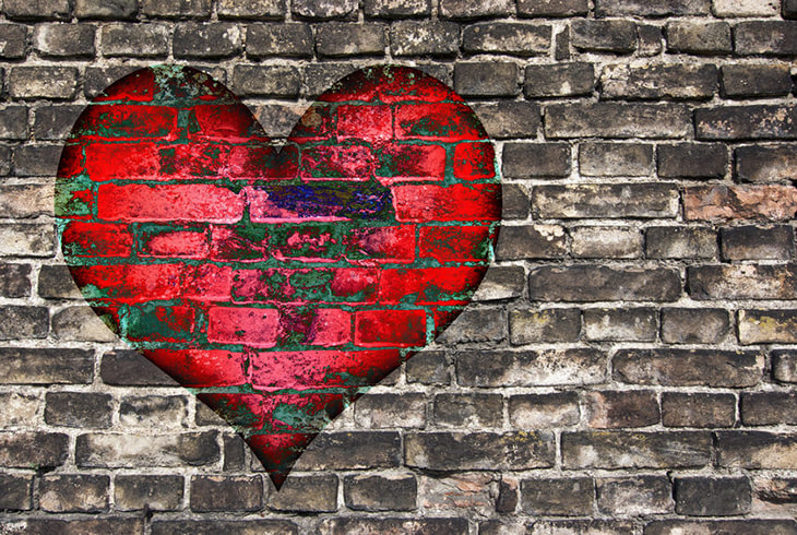 Image: Red heart painted on a brick wall