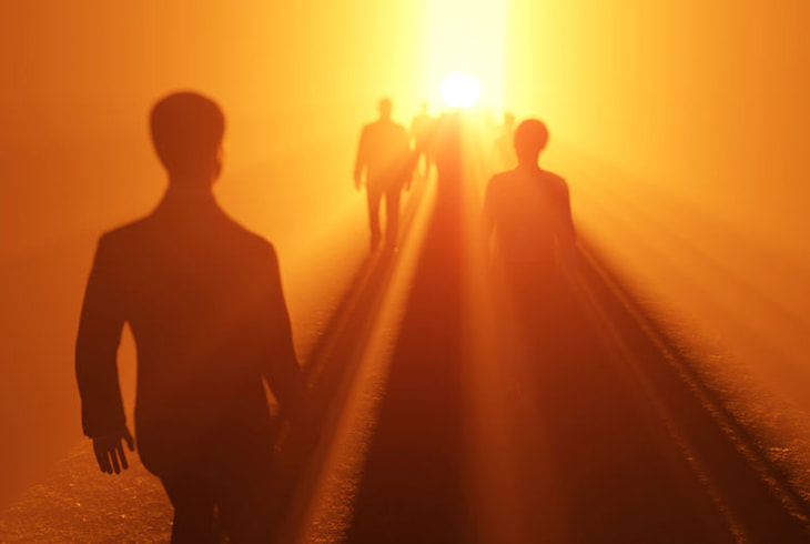 People walking towards the light